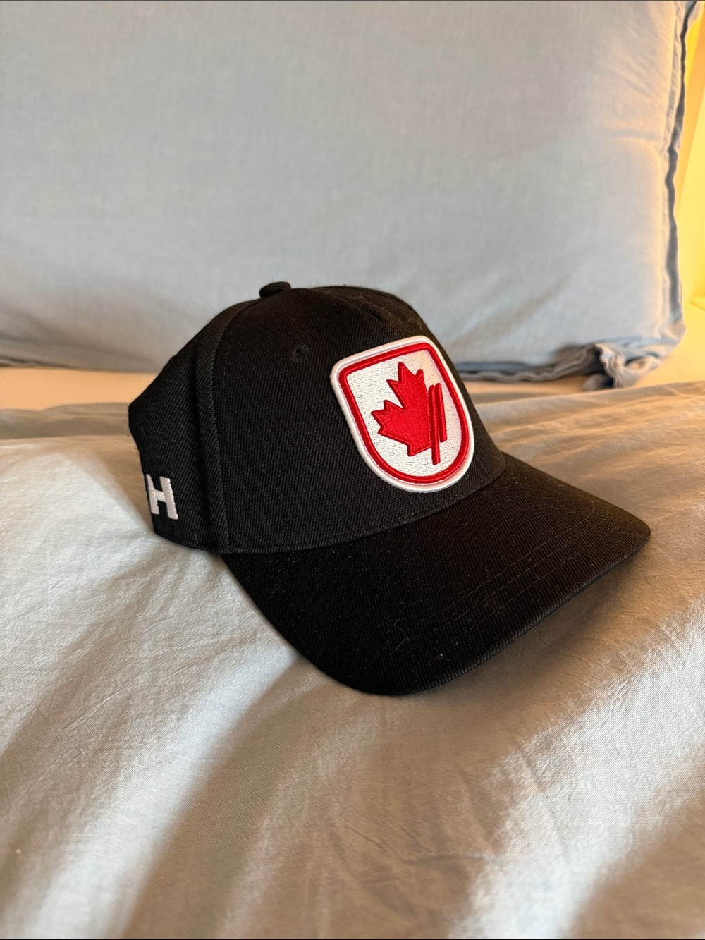 Helly Hansen Black Hat with Red Maple Patch